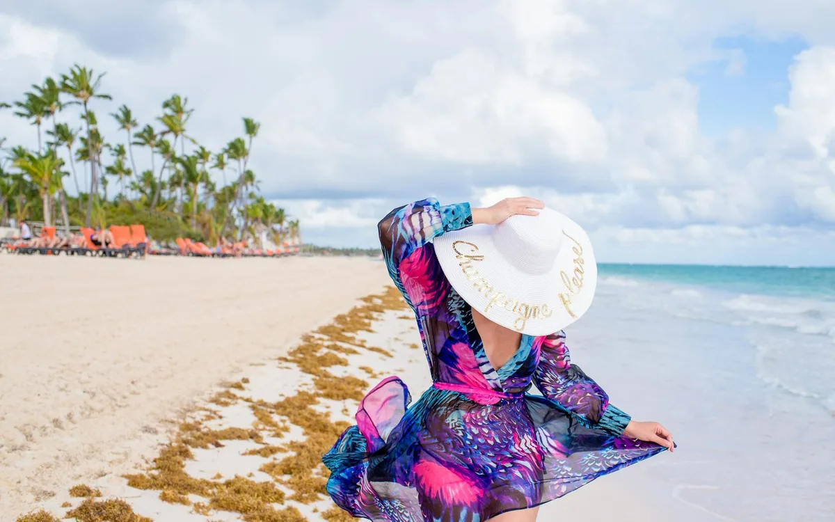 Girl in a white hat on the beach
